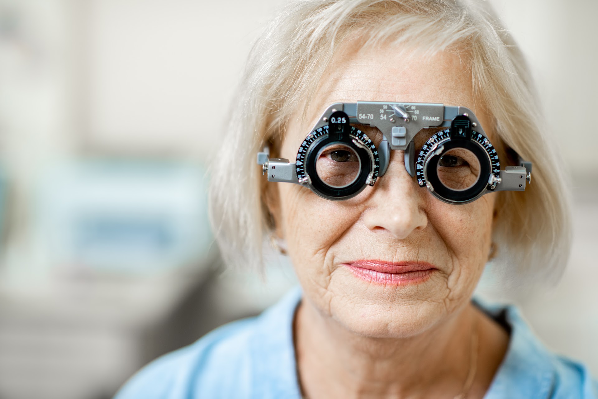 An older woman wearing trial frames during an eye examination